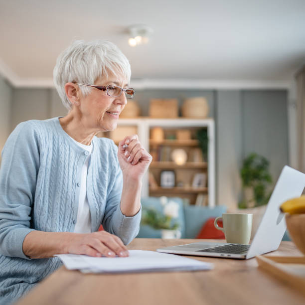 istock Senior caucasian woman use laptop computer at home for work 1586050115
