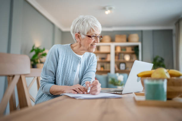 istock Senior caucasian woman use laptop computer at home for work 1586050126