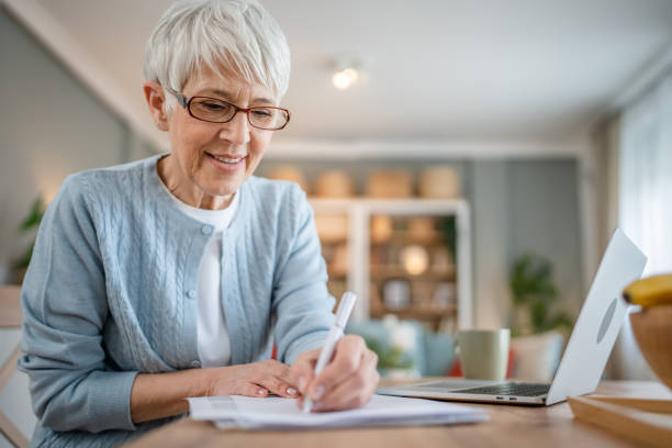 istock Senior caucasian woman use laptop computer at home for work 1586050137