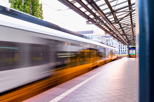 A striking editorial stock image capturing the electrifying energy of a subway train as it glides through the bustling streets of a vibrant city. The sleek, modern design of the train is juxtaposed against the urban landscape, with towering skyscrapers, city lights, and the blur of motion in the background. The dynamic composition and vivid colors in this image evoke the constant movement and pulse of metropolitan life, making it an essential visual asset for conveying the excitement and vitality of city living. Perfect for illustrating the urban transport experience or showcasing the fast-paced rhythm of city life.