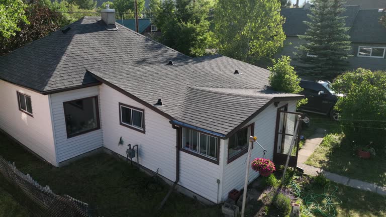 Aerial view of modest older home, in leafy community