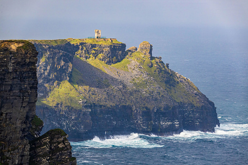 Scenic view of the Moher Tower at Hag's Head in summer at sunrise in Doolin, Ireland
