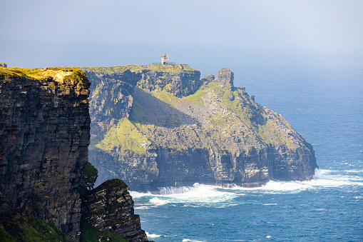 Scenic view of the Moher Tower at Hag's Head in summer at sunrise in Doolin, Ireland