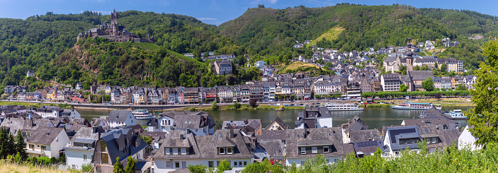Scenic panoramic view of traditional half-timbered houses and a castle on the banks of the Moselle River. Cochem. Germany. Hesse.