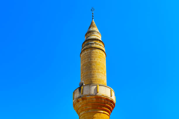 Minaret of a mosque against the blue sky