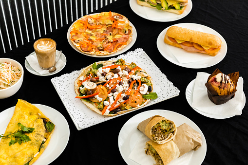 An array of delectable cafe menu items artfully arranged on a table, inviting customers to savor the delightful food and beverage choices.