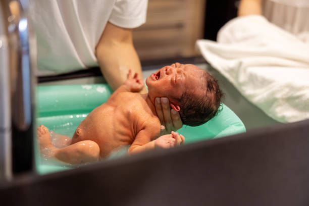 istock Father bathing his baby at home 1586243995