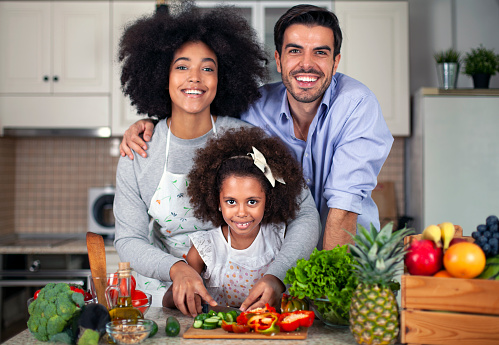 Happy young multiethnicity family in the kitchen.