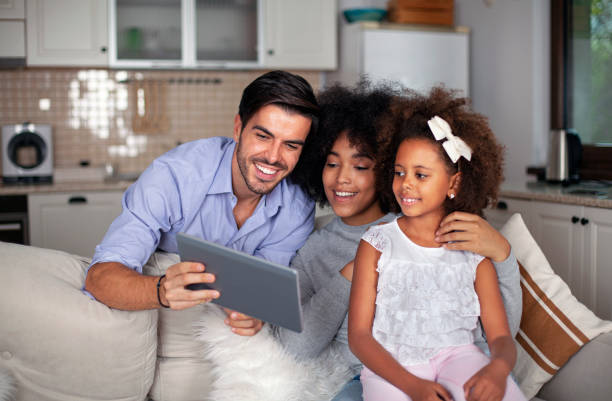 istock Happy family with their daughter enjoying using laptop computer together 1586296931