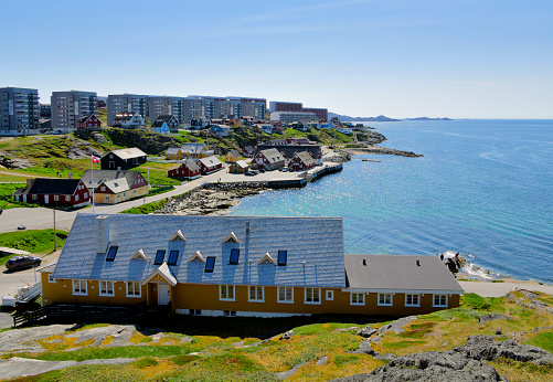 Nuuk / Godthåb, Sermersooq, Greenland:  The Old Hospital (Det Gamle Sygehus) above the old town beach (Qaanniviit street) and the colonial harbor - Nuup Kangerlua / Nuuk / Godthaab fjord (part of the Davis Strait / Labrador Sea / North Atlantic Ocean).