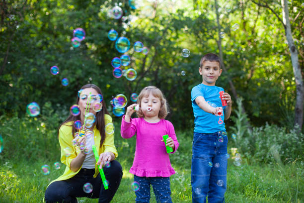 istock Happy family playing with Soap Bubbles 1586301745