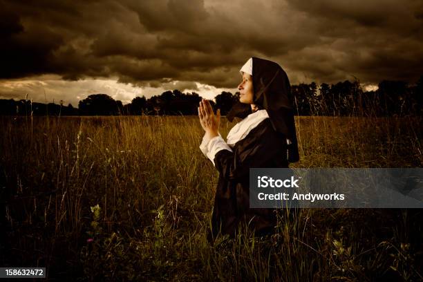 Praying Nun In The Evening Stock Photo - Download Image Now - Nun, Adult, Adults Only