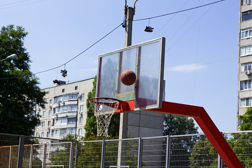 Basketball ball in flight into the ring on the street sports ground of Kharkov
