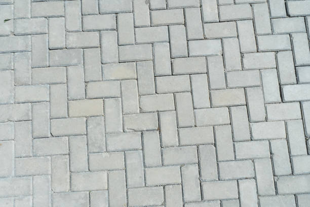 istock Concrete rectangular blocks paving stones herringstone outdoor floorings texture detail 1586344554