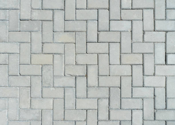 istock Concrete rectangular blocks paving stones herringstone outdoor floorings texture detail 1586349235