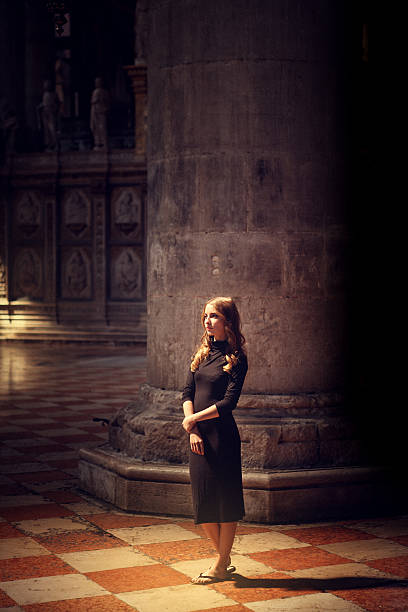 Young woman sitting at a cloister