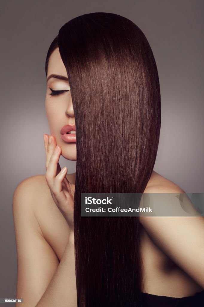 Woman with beautiful hair Studio shot of young beautiful woman on dark background. Professional make up and hair style. Fashion Model Stock Photo