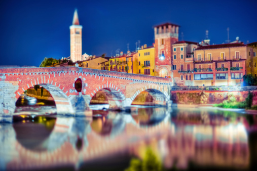 Long exposure shot of the famous Ponte Pietra (Stone Bridge) of Verona, seen at night with a tilt shift lens.