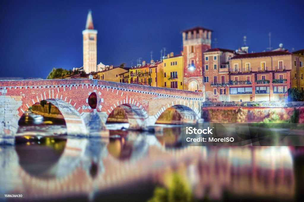 Verona by Night, Ponte Pietra, Italy Long exposure shot of the famous Ponte Pietra (Stone Bridge) of Verona, seen at night with a tilt shift lens. Adige River Stock Photo