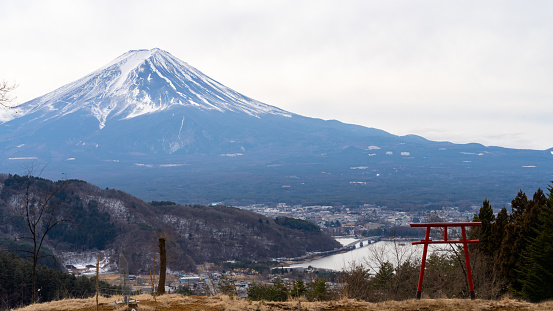 Landscape of beautiful nature of lake Kawaguchi with mt Fuji covered in snow with Fujikawaguchiko town in winter season. Holiday travel vacation and famous place in Japan concept.