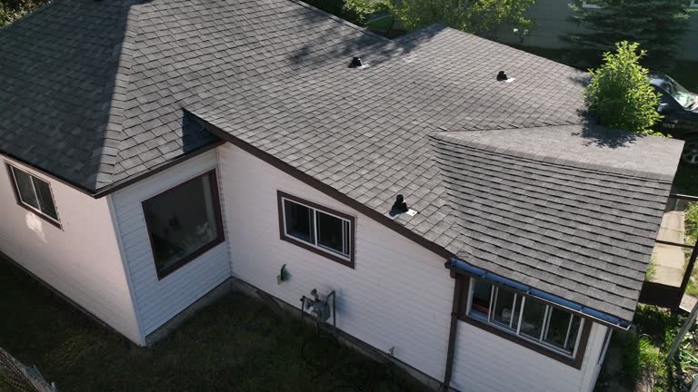 Aerial view of modest older home, in leafy community