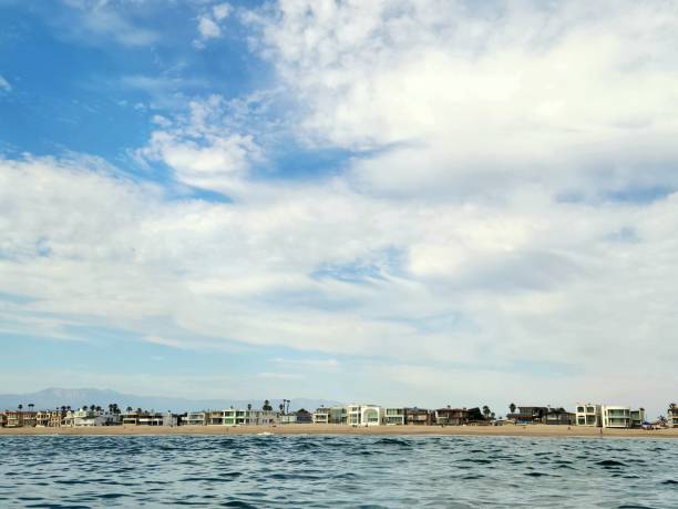 Housing development on the Chesapeake Bay at low tied show the upscale beach homes with beautiful cloudscape.