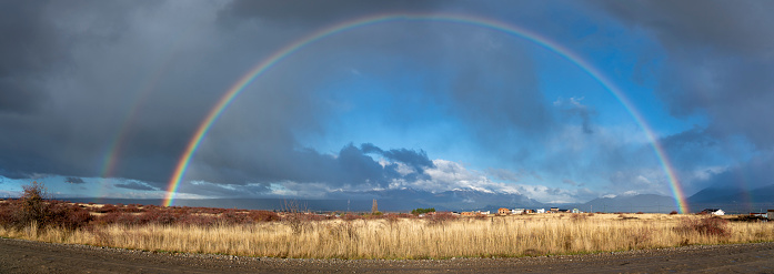 Panoramic view of a double rainbow over Trevelin town in Patagonia in Trevelin, Chubut Province, Argentina