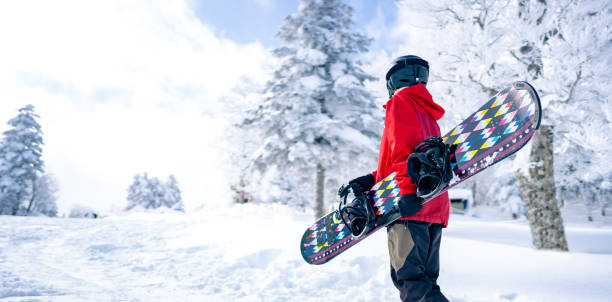 Portrait of Asian woman practice snowboarding at ski slope Portrait of Asian woman practice snowboarding on snow mountain at ski resort. Attractive girl enjoy and fun outdoor active lifestyle travel nature and winter extreme sport training on holiday vacation japanese snowboarder stock pictures, royalty-free photos & images