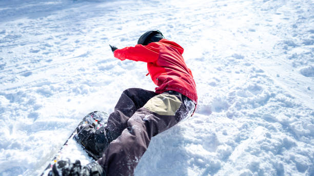 istock Asian woman practice snowboarding at ski slope 1586463135