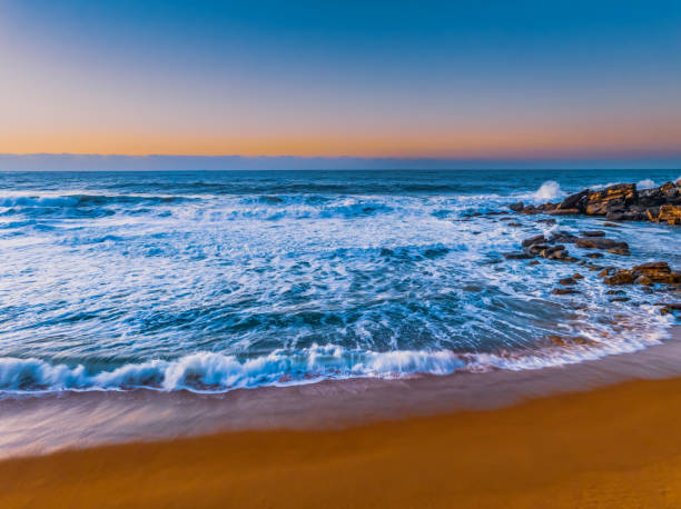 istock Sunrise and waves at the seaside 1586483373