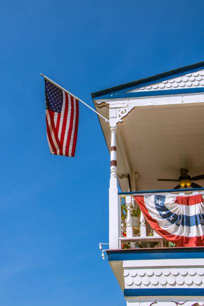 istock American flag attached to an old building against a blue sky 1586493227