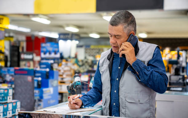 istock Business owner working at a hardware store and talking on the phone 1586522918