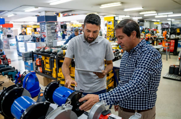 istock Salesman helping a man shopping at a hardware store 1586523439