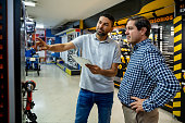 Retail clerk helping a customer buying tools a hardware store