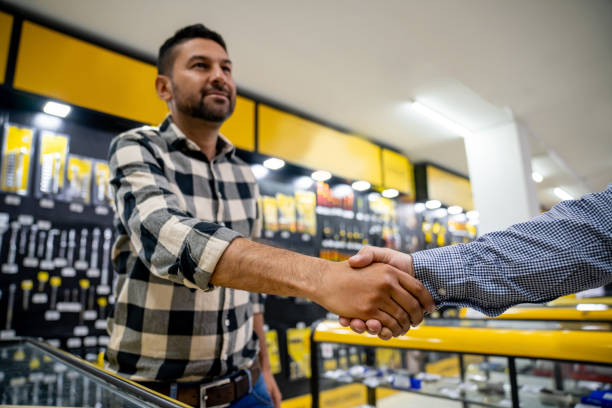 istock Customer handshaking the salesman at the hardware store 1586523985