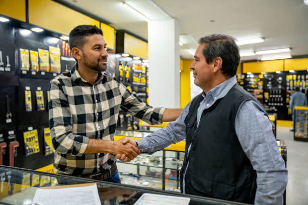 Customer handshaking the retail clerk that help him at the hardware store