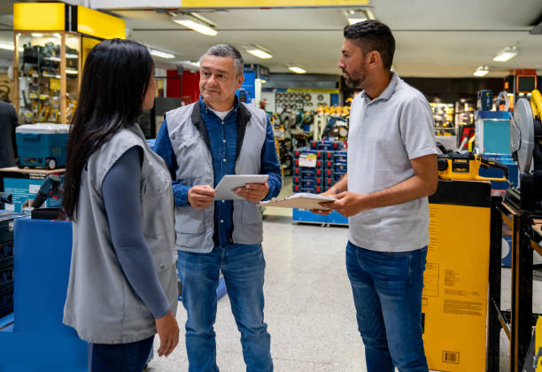 istock Business manager training new employees at a hardware store 1586523996