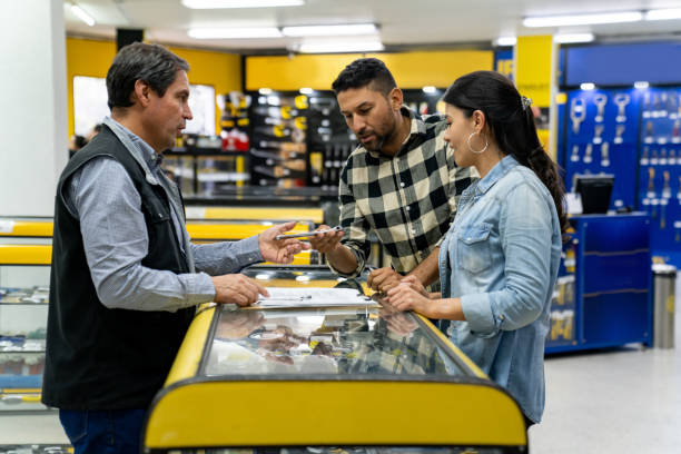 istock Retail clerk helping a couple buying tools at a hardware store 1586524522