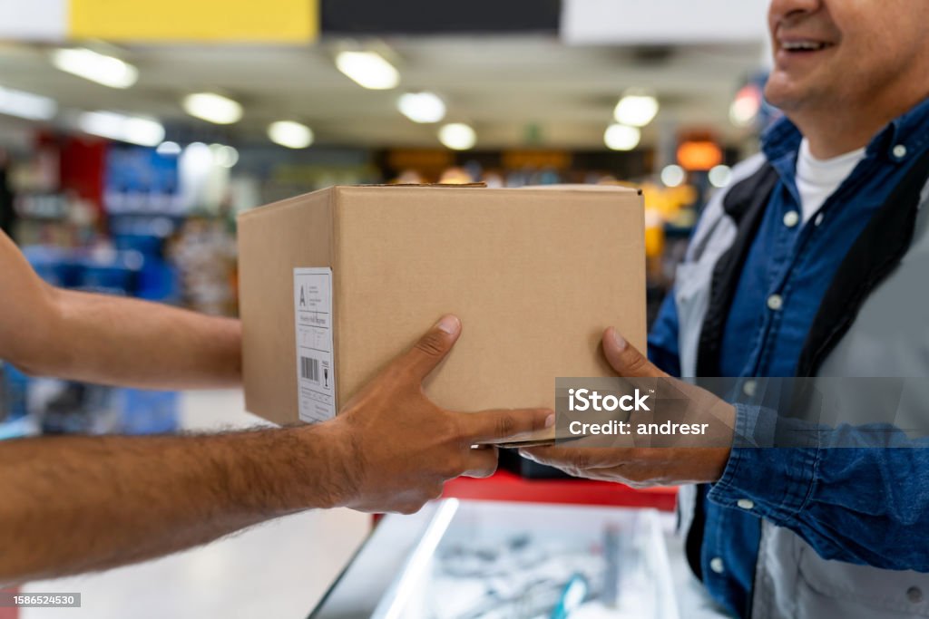 Delivery Picks Delivery Person Picking Up A Package At A Hardware Store Stock Photo ...