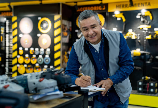 istock Happy salesman working at a hardware store 1586525041