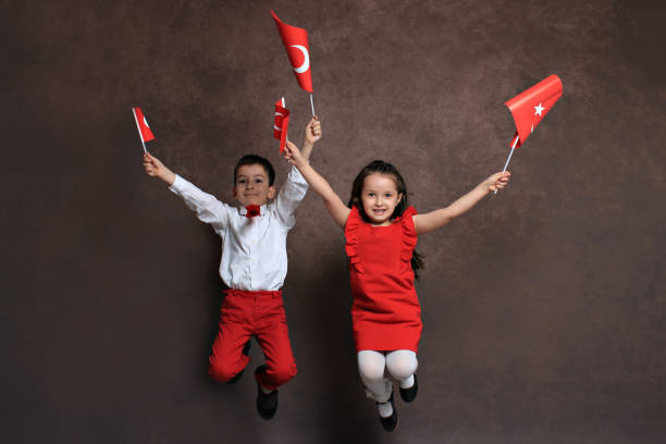 enthusiasm of festival Happy children celebrating on festival with turkish flags in their hands april stock pictures, royalty-free photos & images
