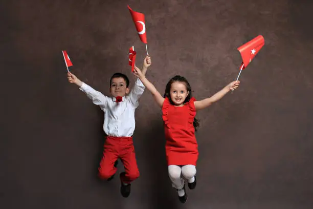 Happy children celebrating on festival with turkish flags in their hands
