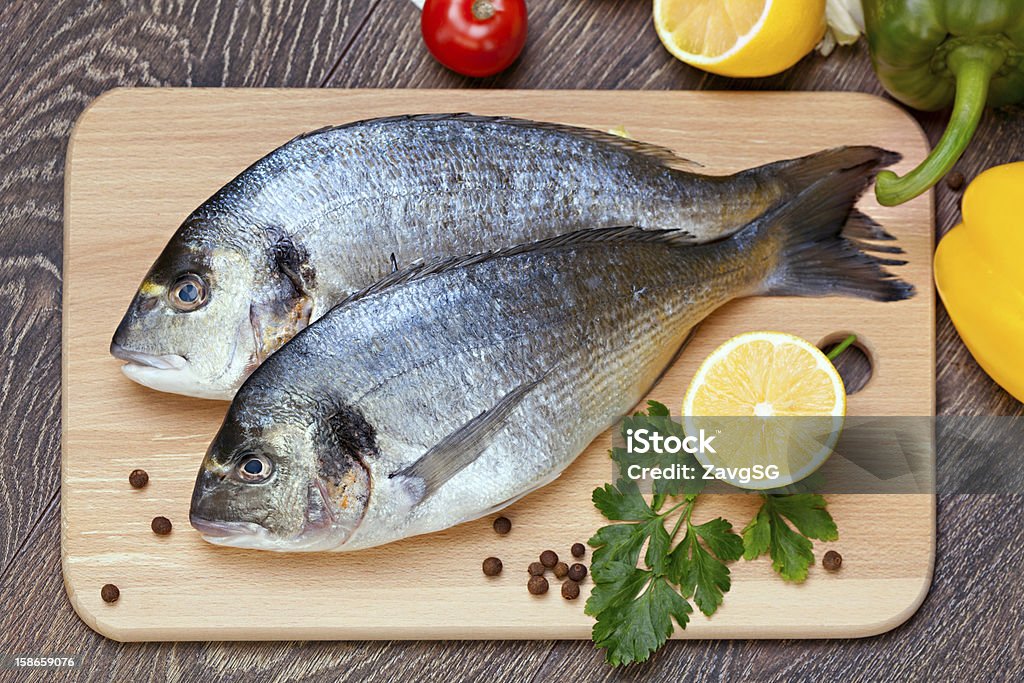 Dorado fish Dorado fish with the vegetables  and lemon Animal Stock Photo