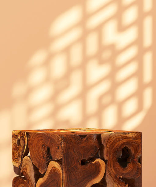 Brown natural log wood cube podium table in sunlight, Chinese round window grill shadow on blank beige cream wall