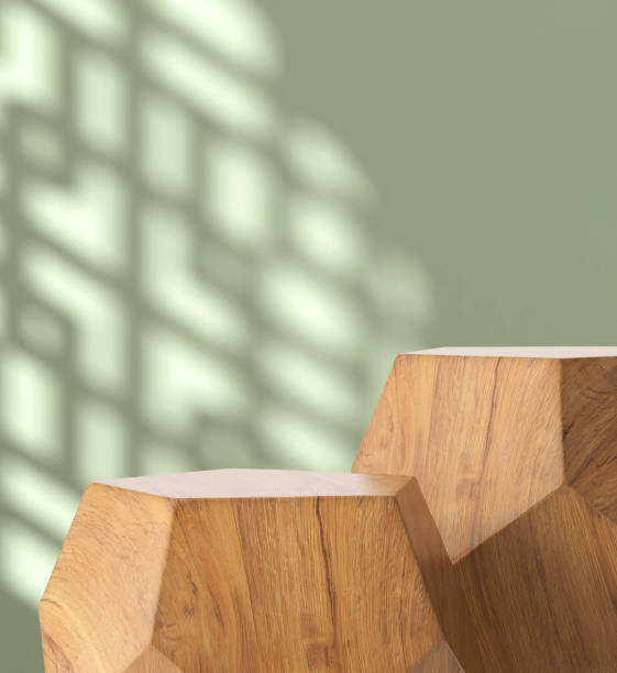 istock Two modern geometric shape brown wooden podium table, pentagon side in sunlight, Chinese window grill shadow on blank green wall 1586593032