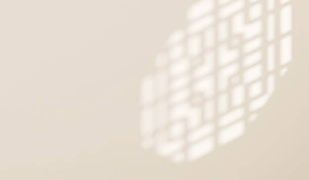 istock Sunlight and shadow of Chinese window grill on cream white wall with space 1586599722