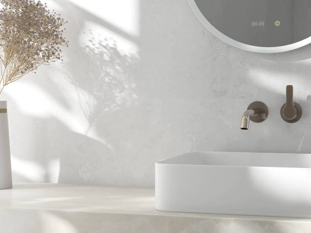 istock Modern round smart vanity mirror with clock, cream marble counter, white rectangle ceramic washbasin, flower vase in sunlight, shadow 1586618698