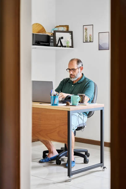 istock Mature man working from home on a laptop 1586621804