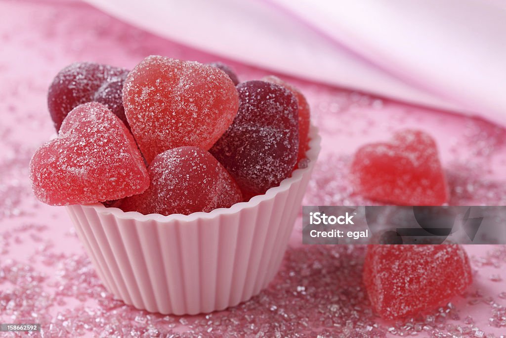 Fruit jellies candy hearts Fruit jellies candy hearts on pink background Anniversary Stock Photo