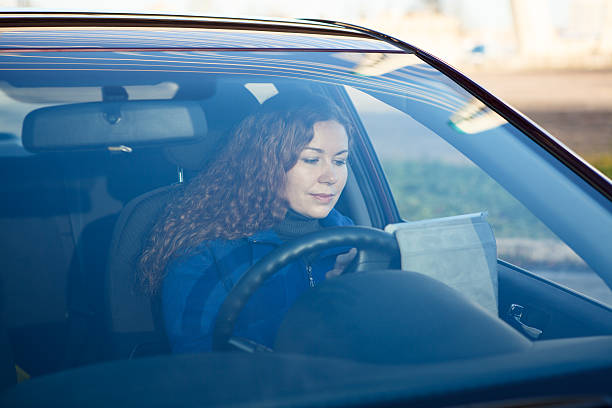 istock Woman with touchpad sitting in car on driver seat 158665040